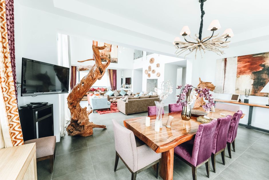 A bright and welcoming living room in a Memphis rental, showcasing unique, non-corporate decor that highlights the personalized guest experience of direct booking.