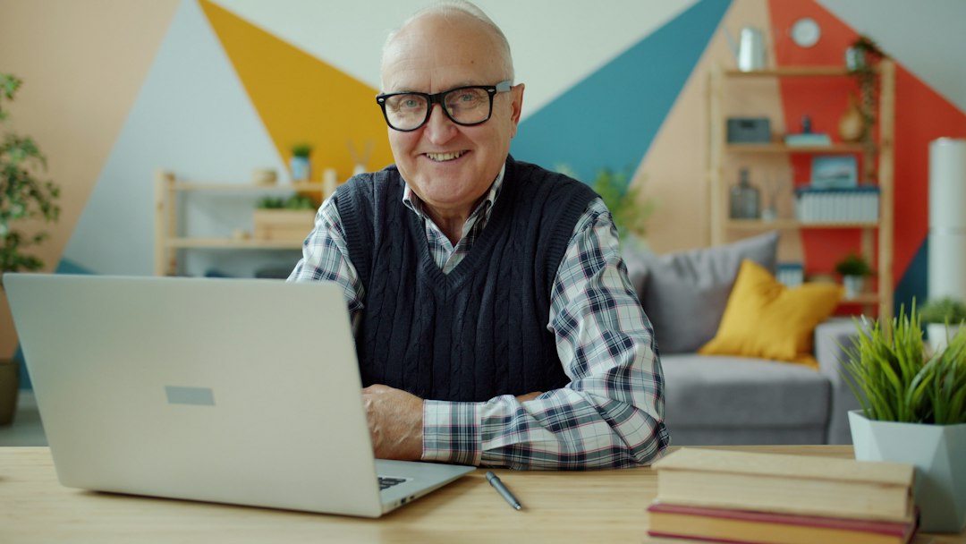 A professional property owner managing their independent STR business on a laptop from inside a bright, stylishly decorated home.